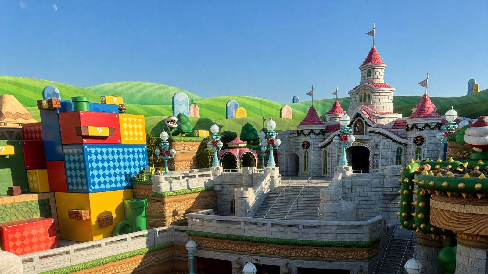 Panoramic view of Princess Peach's Castle with holiday decorations and colorful building blocks in Super Nintendo World at Universal Studios Japan (USJ), Osaka.