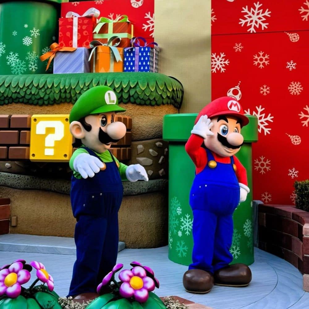 Mario and Luigi costumed characters with holiday decorations in Super Nintendo World at Universal Studios Japan (USJ), Osaka.
