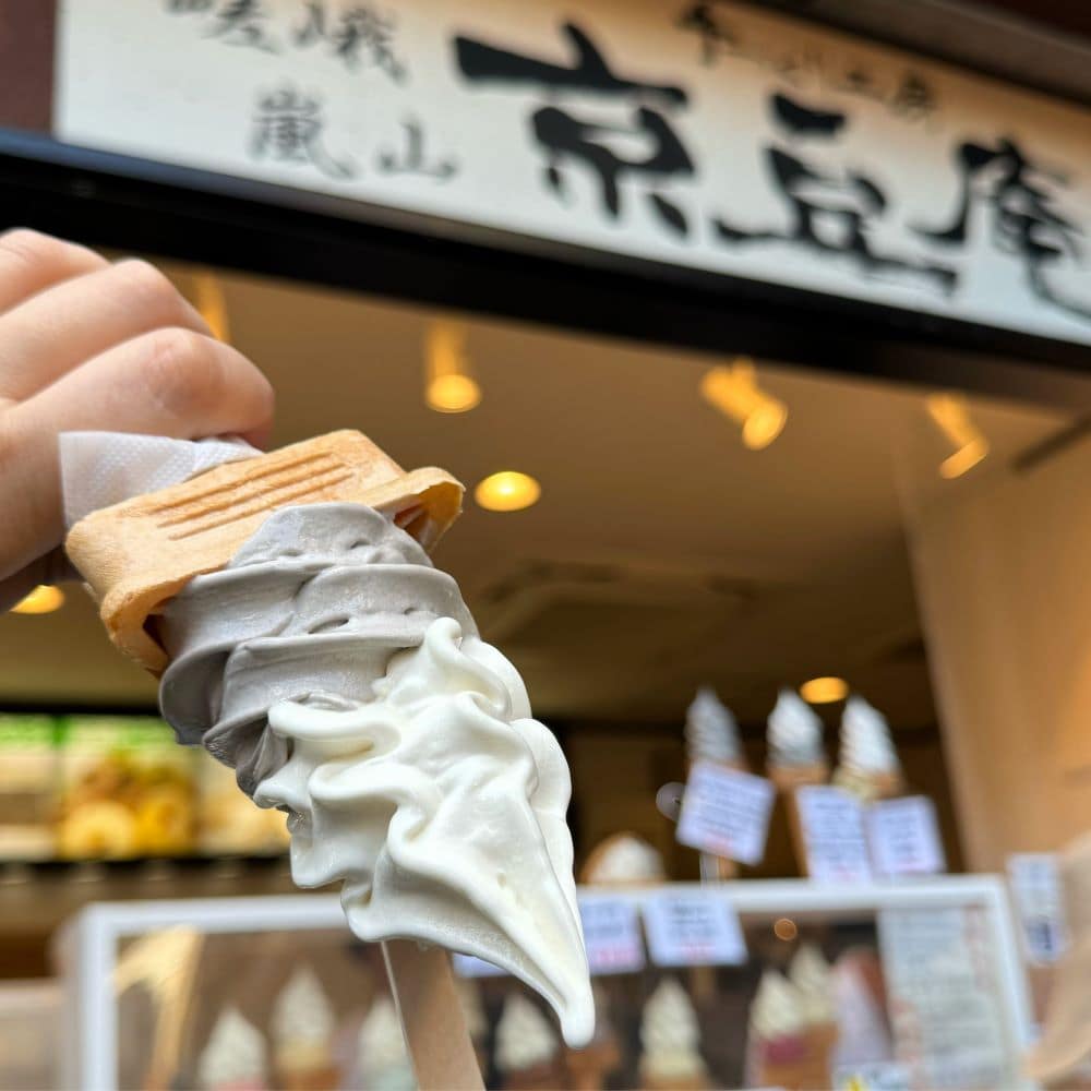 Famous gravity-defying upside-down tofu and black sesame soft serve ice cream held outside the Kyozuan dessert shop in Arashiyama, Kyoto, Japan